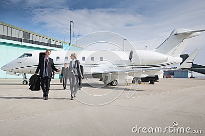 Executive business team leaving corporate jet Stock Photo