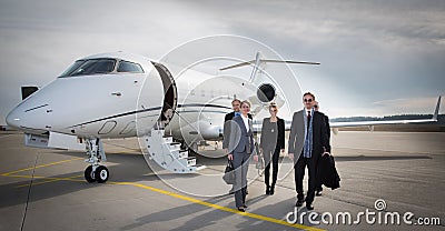 Executive business team leaving corporate jet Stock Photo