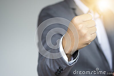 Executive businessman raise up fist hand for accelerate mind for fighting. Young businessman start up and successful concept. Stock Photo