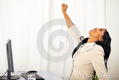 Executive female at work celebrating victory Stock Photo