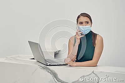 Executive girl making call wearing face mask Stock Photo