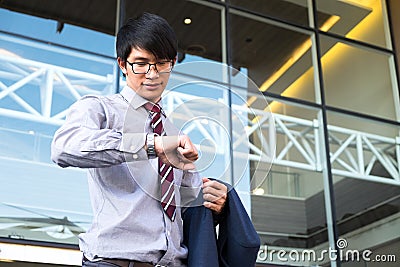 Executive in a hurry, businessman looking at his watch on hand, Stock Photo