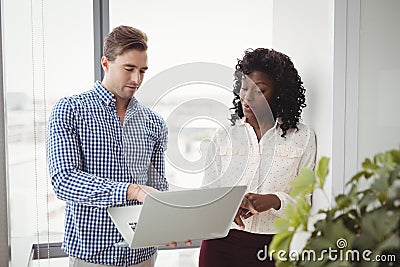 Executives discussing over laptopE Stock Photo