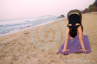 Exercise on beach girls yoga trainer at home yoga. Stock Photo