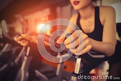 Exercise bike cardio workout at fitness gym Stock Photo