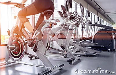 Exercise bike cardio workout at fitness gym Stock Photo