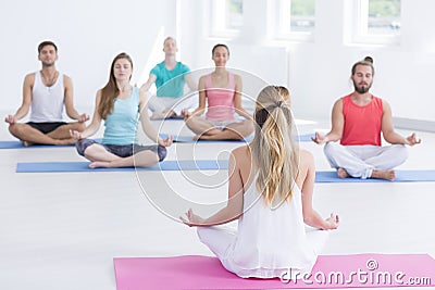 Exercise class practicing yoga indoors Stock Photo