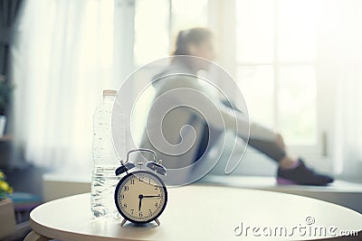 Exercise in the morning water bottle and alarm-clock Stock Photo