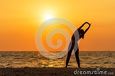 Exercise spirit lifestyle mind woman peace vitality, silhouette outdoors on the Sea sunrise, relax vital abstract. Stock Photo