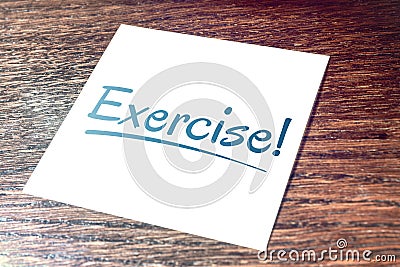 Exercise Sticky Note On Paper Lying On Wooden Cupboard Stock Photo