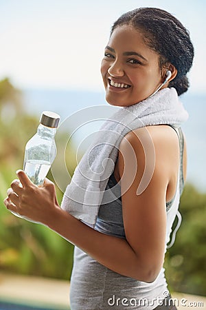 Exercising gives me a great sense of wellbeing. Portrait of a sporty young woman out for a run. Stock Photo