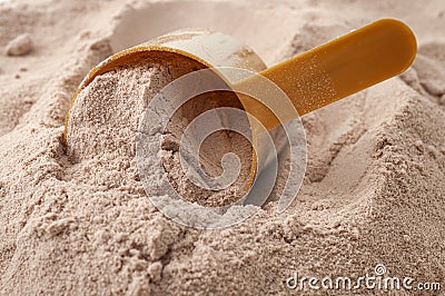 Exercising , weight loss shake and muscle gain conceptual idea with close up on scoop of chocolate flavoured post workout whey Stock Photo