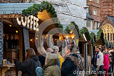 Exeter Christmas market with shoppers buying hot coffee Editorial Stock Photo