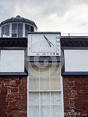 EXETER, DEVON, UK - August 6 2021: Vertical sundial mounted above the entrance of the Devon and Exeter Institution Editorial Stock Photo