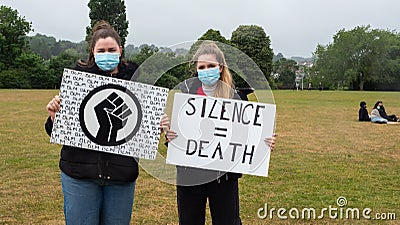 EXETER, DEVON, UK - June 06 2020: Two white women hold signs at a Black Lives Matter demonstration Editorial Stock Photo