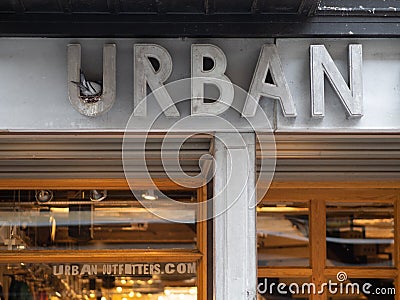 EXETER, UNITED KINGDOM - NOVEMBER 6 2019: Urban Outfitters shop front sign in Exeter city centre with a pigeon nesting in the firs Editorial Stock Photo