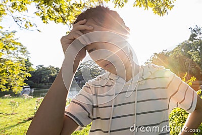 Exhausted asian child girl suffer from sunburn very hot in summer weather problem feel faint,woman with heat stroke,high Stock Photo