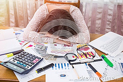 Exhausted business analyst sleeps on her workplace. Stock Photo