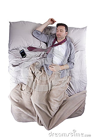 Exhausted businessman with alarm clock Stock Photo