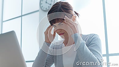 Exhausted businesswoman with headache Stock Photo