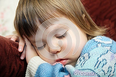 Exhausted child sleeping portrait on chair closeup, tired kid fall asleep Stock Photo