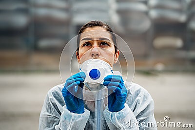 Exhausted doctor/nurse wearing coronavirus protective gear N95 mask uniform.Coronavirus Covid-19 outbreak.Mental stress of Stock Photo