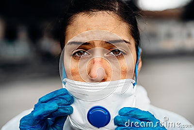 Exhausted doctor/nurse wearing coronavirus protective gear N95 mask uniform.Coronavirus Covid-19 outbreak.Mental stress of Stock Photo