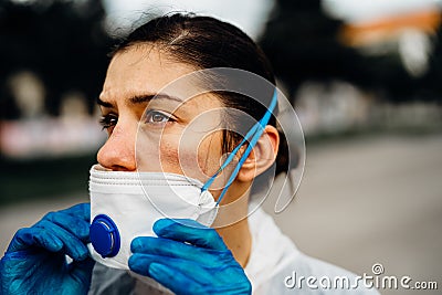 Exhausted doctor/nurse wearing coronavirus protective gear N95 mask uniform.Coronavirus Covid-19 outbreak.Mental stress of Stock Photo