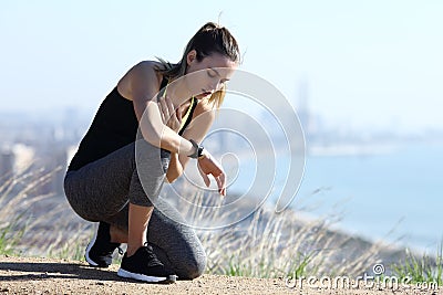 Exhausted jogger checking pulsations on smartwatch outdoors Stock Photo