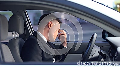 Exhausted male in formal suit sitting on driver seat, stressful life, overwork Stock Photo