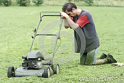 Exhausted Man with Lawn Mower Stock Photo
