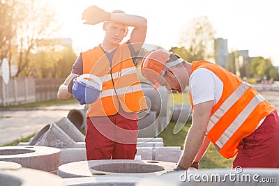 Exhausted manual workers Stock Photo