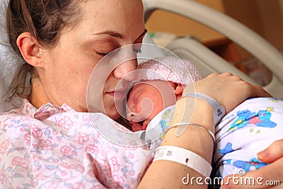 Exhausted Mom and Newborn Stock Photo