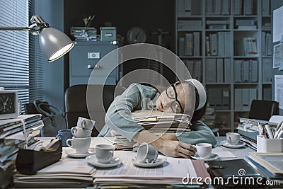 Exhausted office worker falling asleep in the office Stock Photo