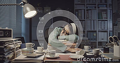 Exhausted office worker falling asleep in the office Stock Photo