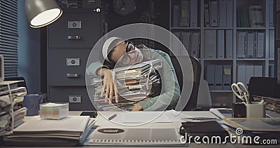 Exhausted office worker sleeping in the office Stock Photo