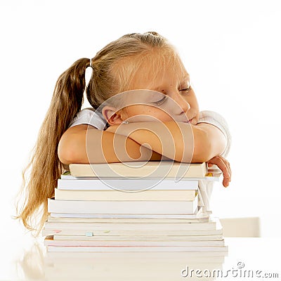 Exhausted schoolgirl falling asleep on her books after studying too much Stock Photo