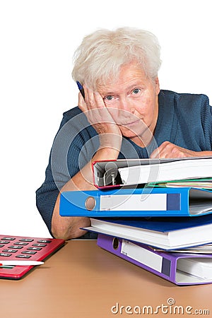 Exhausted senior lady with paperwork Stock Photo