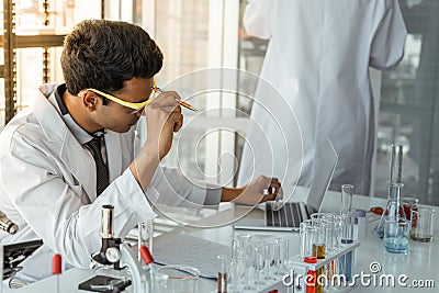Exhausted stressed research scientists feeling tired worried about problem in chemical laboratory Stock Photo