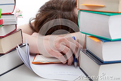 Exhausted student behind a books Stock Photo