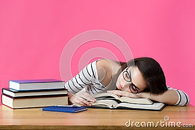 Exhausted student sleeping at her desk Stock Photo