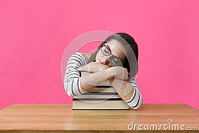 Exhausted student sleeping at her desk Stock Photo