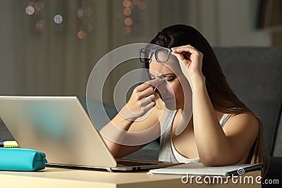 Exhausted student suffering eyestrain in the night Stock Photo