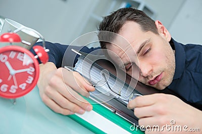 Exhausted worker sleeping in office Stock Photo