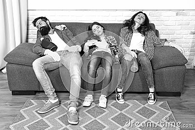 Exhausting cleaning day. Family mom dad and daughter with cleaning supplies sit on couch. Family care about cleanliness Stock Photo