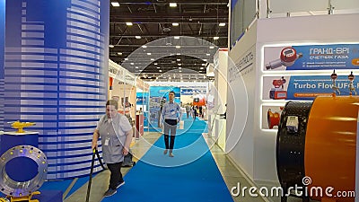 Exhibition in a new convention and conference expo center. Cleaning woman vacuuming the floor in trade show hall. Service staff. Editorial Stock Photo