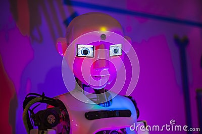 Exhibition of Robotics. Stylish handsome cyborg head / Robot Assistant with Information screen Editorial Stock Photo