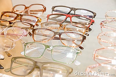 Exhibitor of glasses consisting of shelves of fashionable glasses shown on a wall at the optical shop. optics, health Stock Photo