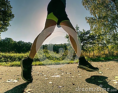 Exigent physical training. The athlete runs fast through alley Stock Photo