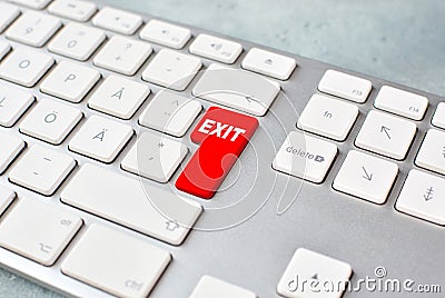 Exit concept with keyboard and red key. Stock Photo